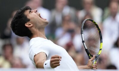 Carlos Alcaraz of Spain celebrates after defeating Daniil Medvedev of Russia in their semifinal match at the Wimbledon tennis championships in London, Friday, July 12, 2024. (AP Photo/Mosa'ab Elshamy)