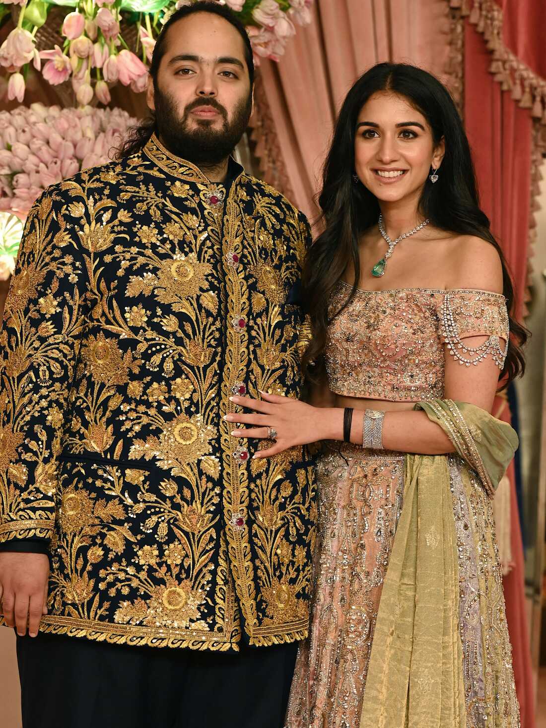 Anant Ambani son of billionaire tycoon and Chairman of Reliance Industries Mukesh Ambani (unseen) with his fiancee Radhika Merchant pose for a picture during their Sangeet Ceremony in Mumbai, on July 5, 2024. (Photo by SUJIT JAISWAL / AFP) (Photo by SUJIT JAISWAL/AFP via Getty Images)