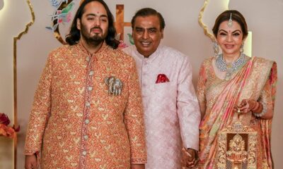 Billionaire tycoon and Chairman of Reliance Industries Mukesh Ambani (C), wife Nita Ambani (R) and son Anant Ambani pose for photos as they arrive to attend the wedding ceremony of Anant and his fiancee Radhika Merchant in Mumbai on July 12, 2024.