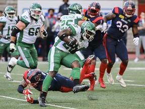 Saskatchewan Roughriders running back Frankie Hickson (20) evades a tackle during first half CFL football action against the Montreal Alouettes in Montreal, Thursday, July 25, 2024.