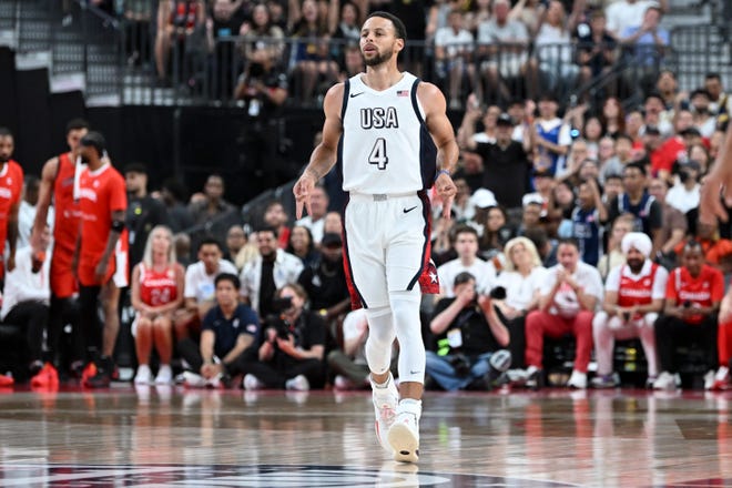 Steph Curry celebrates after scoring against Canada.