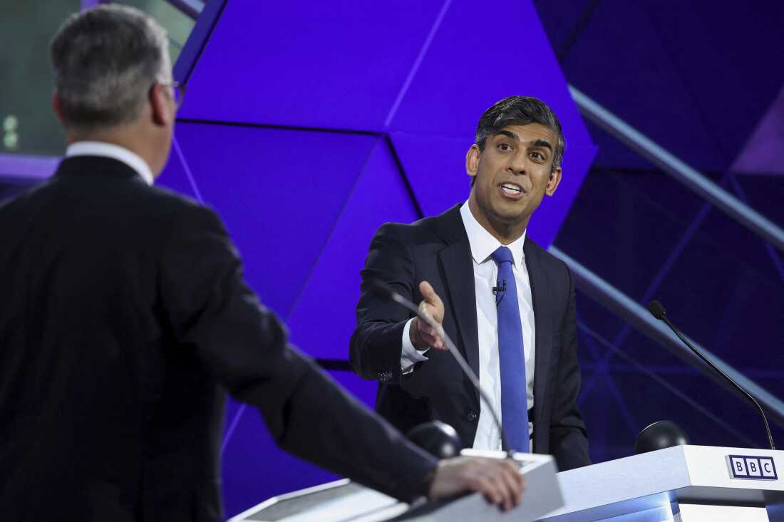 British Prime Minister Rishi Sunak and opposition Labour Party leader Keir Starmer (with back to camera) take part in the BBC's prime ministerial debate, in Nottingham, England, on June 26.