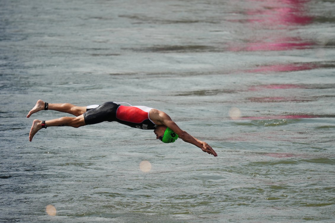 Tyler Mislawchuk dives into the water during the triathlon