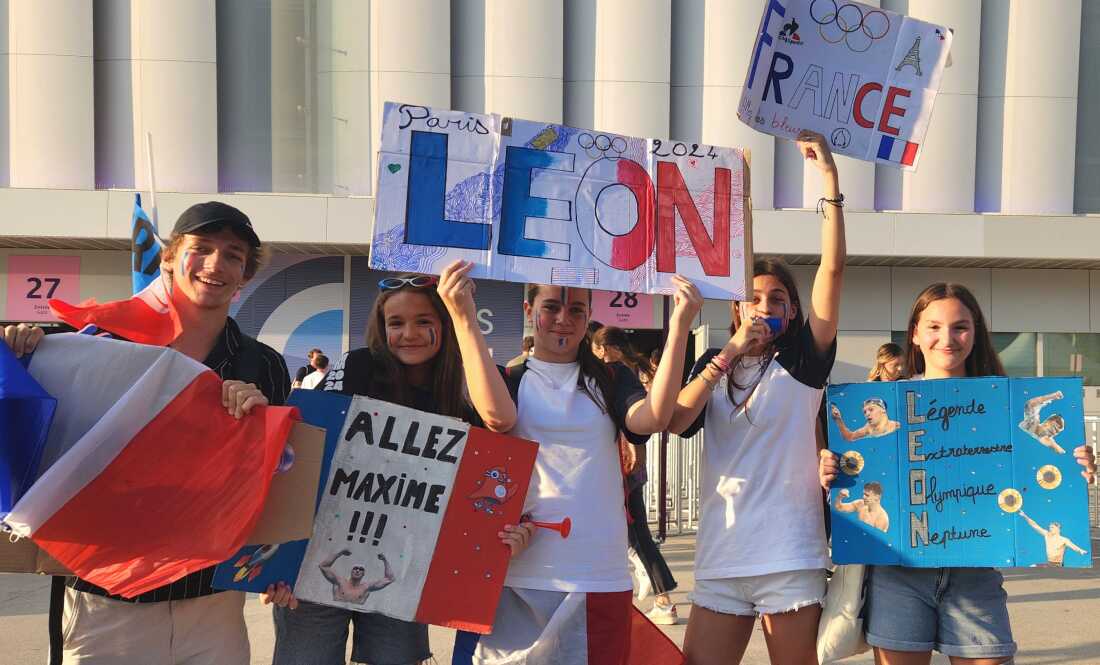 Young fans gathered outside La Defense arena in a Paris suburb Friday to cheer on their new swimming hero, Leon Marchand. He came through for them, winning a fourth gold medal.