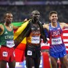 Gold medalist Joshua Cheptegei, of Uganda, poses with silver medalist Berihu Aregawi, of Ethiopia, left, and bronze medalist Grant Fisher, of the United States, after the men's 10,000-meter final at the 2024 Summer Olympics, Friday, in Saint-Denis, France.