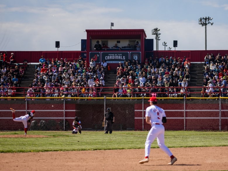 Crowd at a baseball game with a player in the foreground.