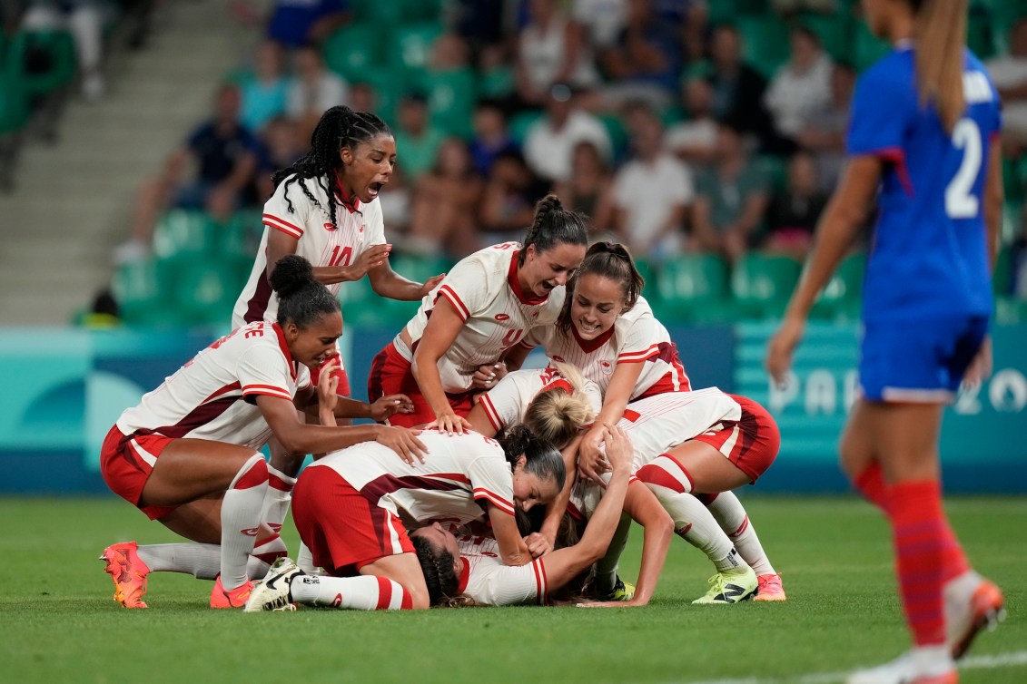 Team Canada players celebrate Vanessa Gilles' late goal against France.