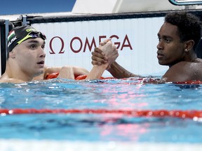 Kristof Milak of Team Hungary and Josh Liendo of Team Canada congratulate each other after winning Gold and Silver in the Men's 100m Butterfly Final.