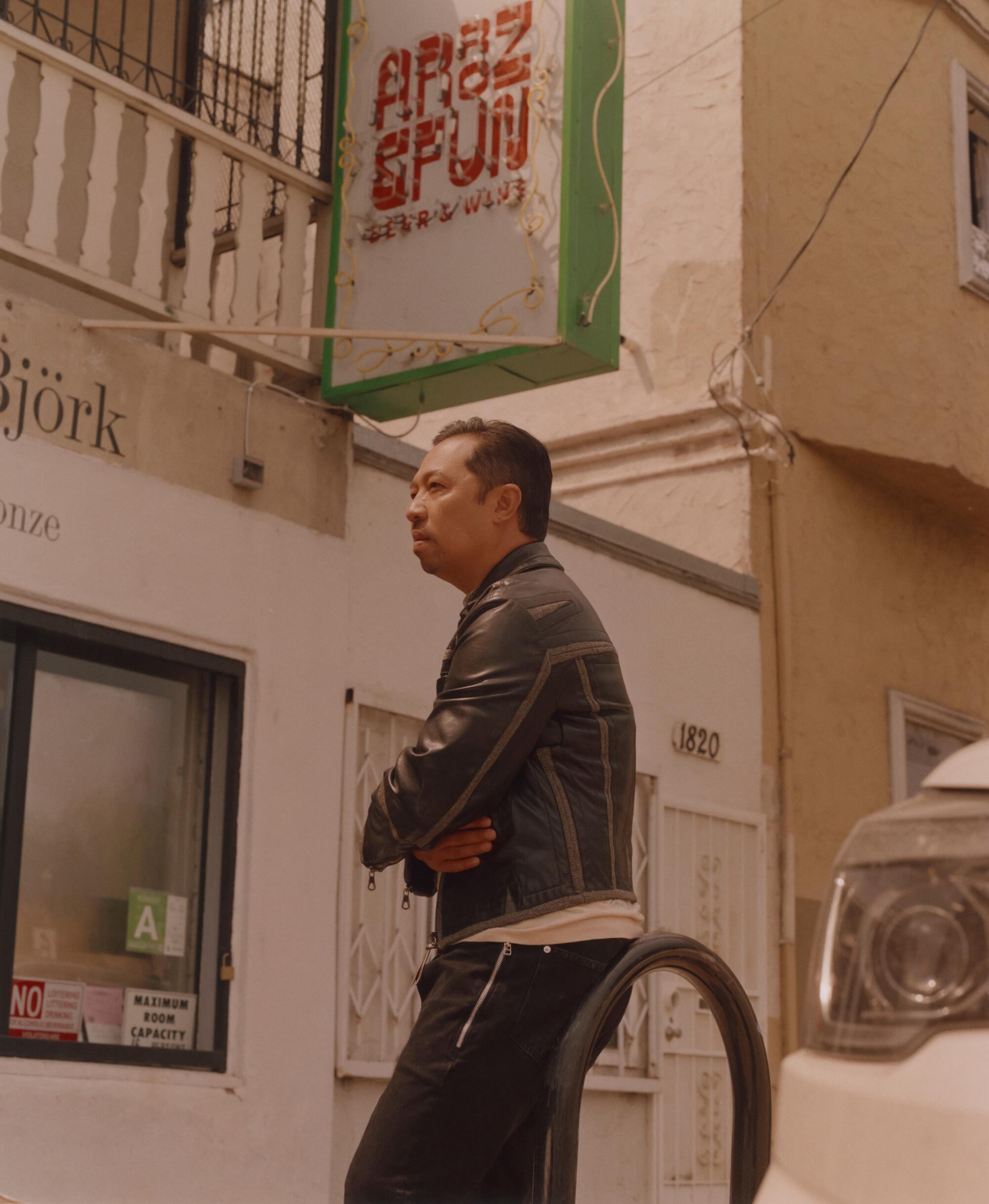 Humberto Leon stands on the street in front of his cafe, Arroz & Fun.