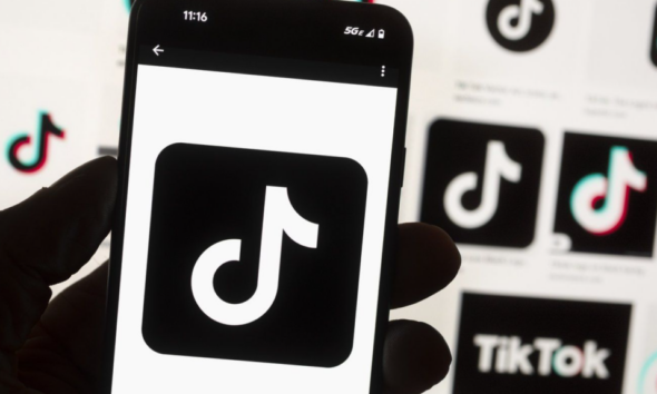 The TikTok logo is displayed on a mobile phone in front of a computer screen, Oct. 14, 2022, in Boston. (Michael Dwyer / AP Photo, File)