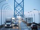 Commercial trucks and passenger vehicles drive across Ambassador Bridge on the Canada-U.S. border in Windsor, Ont. Canada's economy grew at an annualized rate of 2.1 per cent in the second quarter.
