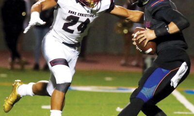 THE MAN WITH THE GOLDEN CLEATS—Zach Charbonnet, left, sacks Westlake QB Jake Kaplinski for Oaks Christian High’s football team on Nov. 3, 2017. Charbonnet, a Camarillo native, is a second-year NFL running back with the Seattle Seahawks. ROB VARELA/Acorn Newspapers