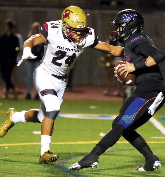 THE MAN WITH THE GOLDEN CLEATS—Zach Charbonnet, left, sacks Westlake QB Jake Kaplinski for Oaks Christian High’s football team on Nov. 3, 2017. Charbonnet, a Camarillo native, is a second-year NFL running back with the Seattle Seahawks. ROB VARELA/Acorn Newspapers