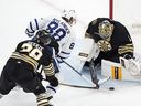 Boston Bruins' Jeremy Swayman blocks a shot by Toronto Maple Leafs' William Nylander as Morgan Geekie  defends during the second period of Game 7, Saturday, May 4, 2024, in Boston. 