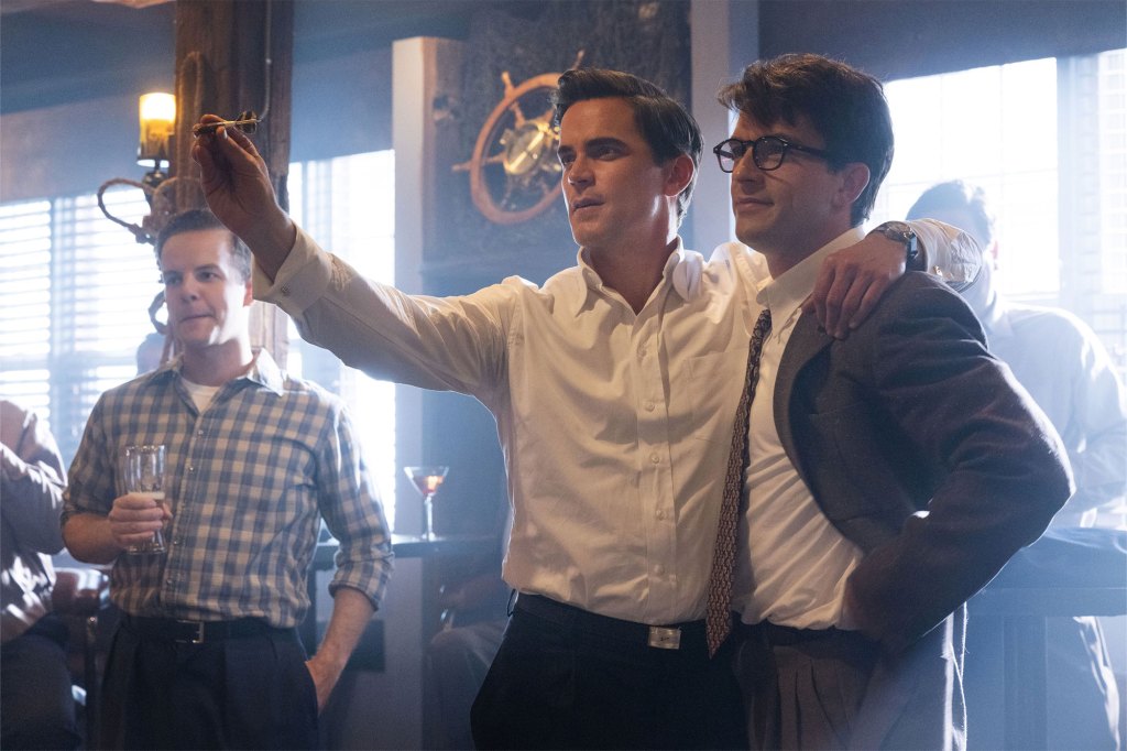 A group of men in a room, including celebrities Matt Bomer and Jonathan Bailey