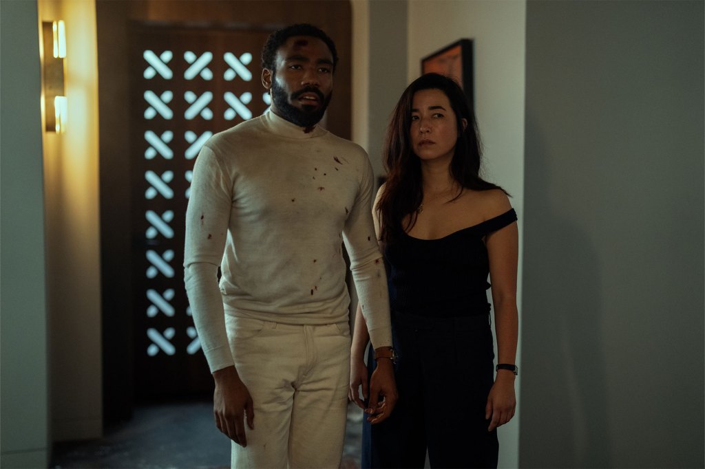 Donald Glover and Maya Erskine standing in a room in a scene from the Prime Video series 'Mr and Mrs Smith'