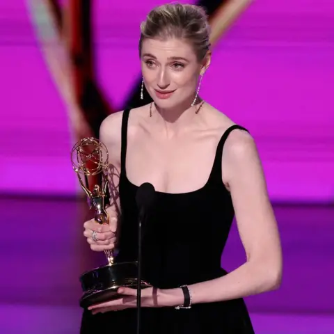 Reuters Elizabeth Debicki holding her Emmy on stage