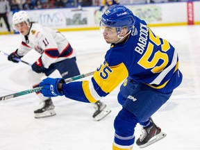 Saskatoon Blades defence John Babcock (55) takes on Regina Pats during WHL action at SaskTel Centre. Photo taken in Saskatoon, Sask. on Sunday, January 14, 2024.