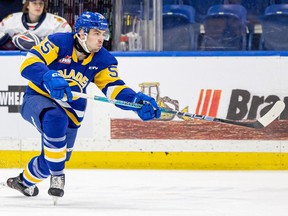 Saskatoon Blades John Babcock takes on Regina Pats during WHL action at SaskTel Centre. Photo taken in Saskatoon, Sask. on Sunday, January 14, 2024.