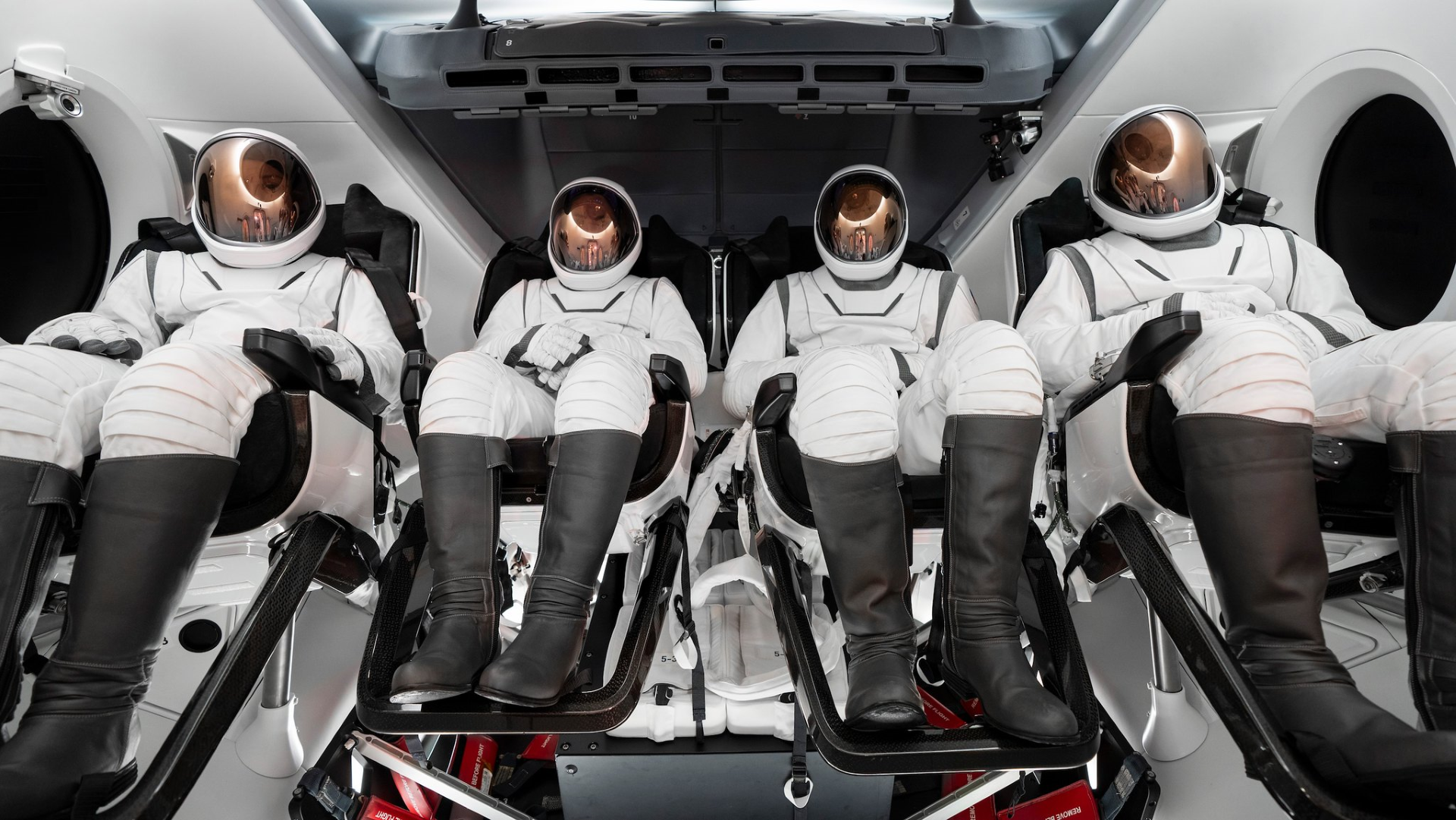 The four-person crew of the Polaris Dawn mission pictured wearing their SpaceX extravehicular activity suits