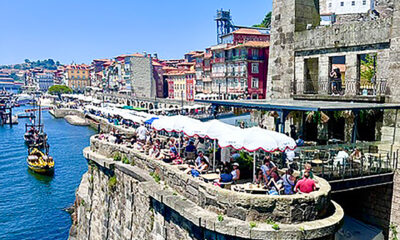 Diners above the water in Porto, Portugal.