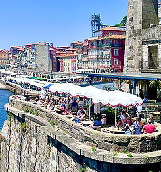 Diners above the water in Porto, Portugal.