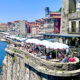 Diners above the water in Porto, Portugal.