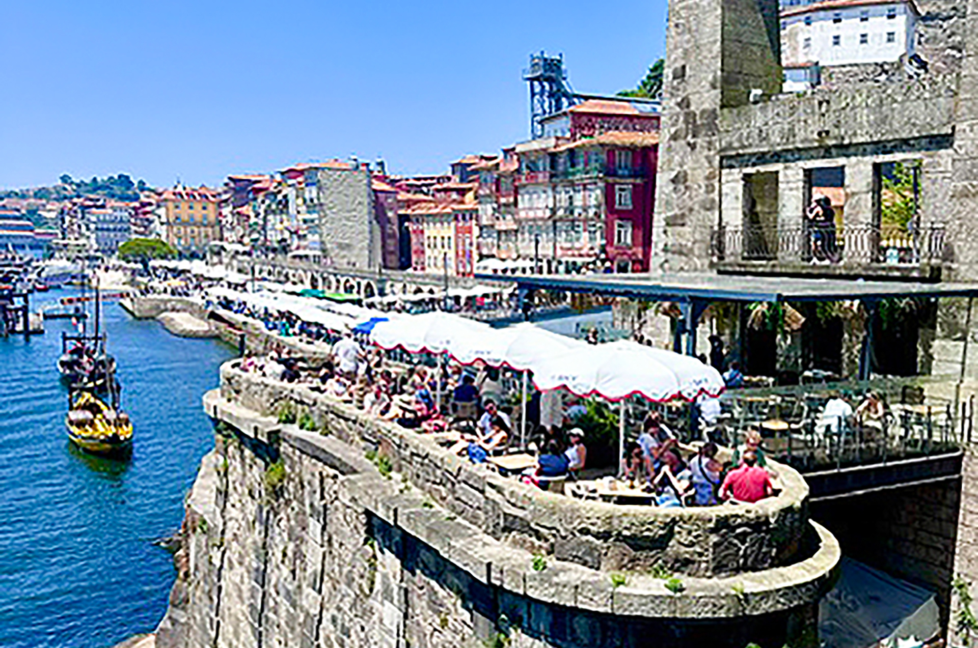 Diners above the water in Porto, Portugal.