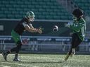 Saskatchewan Roughriders running back Ryquell Armstead (29) takes a ball from quarterback Trevor Harris (7) during a drill during practice at Mosaic Stadium on Tuesday, September 24, 2024 in Regina.