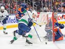 Vancouver Canucks Pius Suter looks for a shot against Edmonton Oilers goalie Stuart Skinner (74) during the first period in Edmonton on Monday night