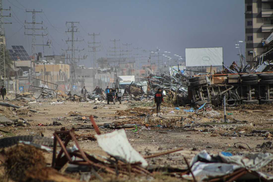 Palestinians among the rubble of destroyed buildings at the Maghazi refugee camp in southern Gaza Strip, on Jan. 21.