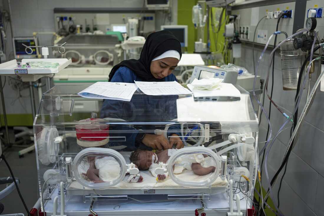 A nurse cares for babies born prematurely at the Emirati Hospital in Rafah, Gaza Strip, on March 8. Doctors there report numerous babies have died of malnutrition-related causes.