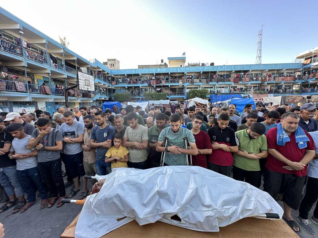 People pray over the body of a person killed in an Israeli airstrike on a U.N.-run school in Nuseirat, central Gaza, in September. The U.N. says hundreds of Palestinians have been killed in U.N. schools that have been turned into shelters for tens of thousands of families displaced across the Gaza Strip.