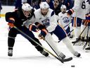 Travis Dermott (24) and Leon Draisaitl (29) take part in the Edmonton Oilers' training camp at Rogers Place, in Edmonton Thursday Sept. 19, 2024. 