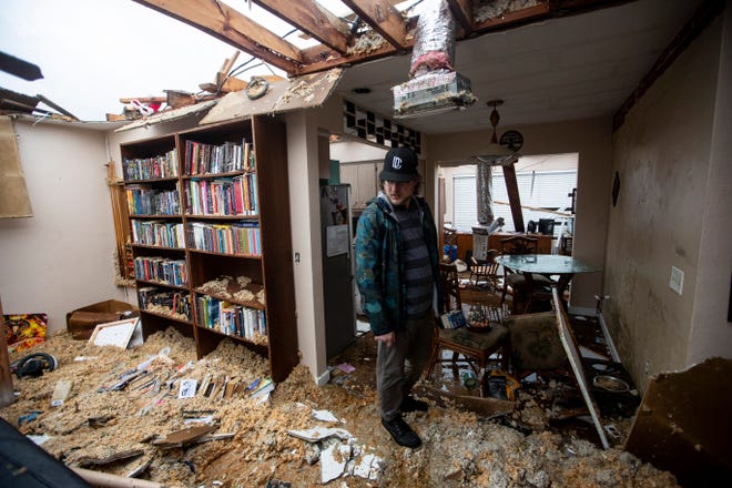 Connor Ferran, a Fort Myers resident looks over his home that was damaged in a possible tornado associated with Hurricane Milton on Wednesday, Oct. 9, 2024.