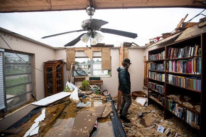 Connor Ferran, a Fort Myers resident looks over his home that was damaged in a possible tornado associated with Hurricane Milton on Wednesday, Oct. 9, 2024.