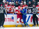 Canucks centre J.T. Miller takes on hulking Flames winger Anthony Mantha in the first period Wednesday at Rogers Arena.