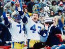 Winnipeg Blue Bomber John Bonk, with Grey Cup in his left hand, raises his right hand in jubilation along with teammate Vernon Pahl after the Blue Bombers beat Hamilton Tiger-Cats 47-17 in Edmonton on Nov. 18, 1984, to win the 1984 Canadian Football League championship. At right of picture is CFL commissioner Doug Mitchell. 