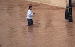 A woman walks through flooded streets in Valencia, Spain.