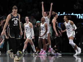 From left, Minnesota Lynx's Bridget Carleton (6), Courtney Williams, Alanna Smith and Napheesa Collier celebrate after defeating the New York Liberty in overtime in Game 1 of the WNBA final Thursday, Oct. 10, 2024, in New York. (AP Photo/Pamela Smith)