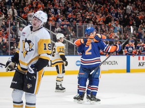 Pittsburgh Penguins' Cody Glass (19) and Anthony Beauvillier (72) skate away as Edmonton Oilers' Evan Bouchard (2)