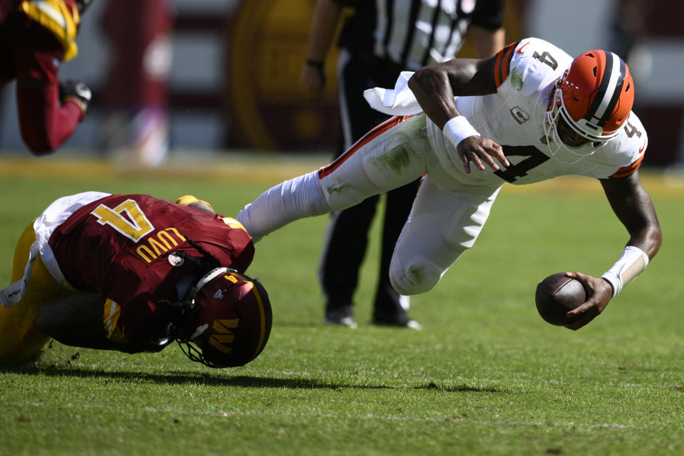 Cleveland Browns quarterback Deshaun Watson, right, is tackled by Washington Commanders linebacker Frankie Luvu. (AP Photo/Nick Wass)