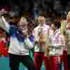 Lim Jong-hoon of South Korea takes a selfie with North Korean silver medalists Kim Kum-yong and Ri Jong-sik, center, with Chinese gold medalists Wang Chuqin and Sun Yingsha flanking South Korean Shin Yu-bin.