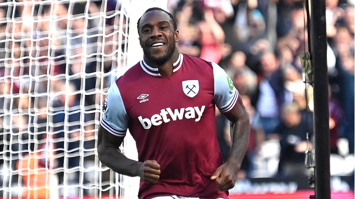 West Ham striker Michail Antonio smiling, celebrating, running away from a goal.