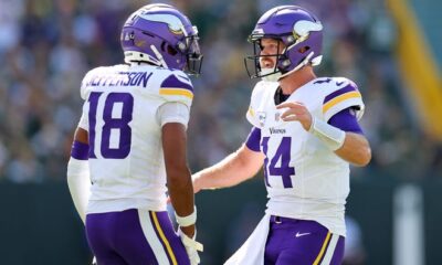 GREEN BAY, WISCONSIN - SEPTEMBER 29: Justin Jefferson #18 and Sam Darnold #14 of the Minnesota Vikings celebrate a touchdown against the Green Bay Packers during the first quarter of the game at Lambeau Field on September 29, 2024 in Green Bay, Wisconsin. (Photo by Stacy Revere/Getty Images)