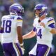 GREEN BAY, WISCONSIN - SEPTEMBER 29: Justin Jefferson #18 and Sam Darnold #14 of the Minnesota Vikings celebrate a touchdown against the Green Bay Packers during the first quarter of the game at Lambeau Field on September 29, 2024 in Green Bay, Wisconsin. (Photo by Stacy Revere/Getty Images)