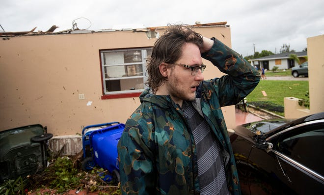 Connor Ferran, a Fort Myers resident reacts after his home was damaged in a possible tornado associated with Hurricane Milton on Wednesday, Oct. 9, 2024.