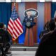 A man speaks from a podium to an audience.