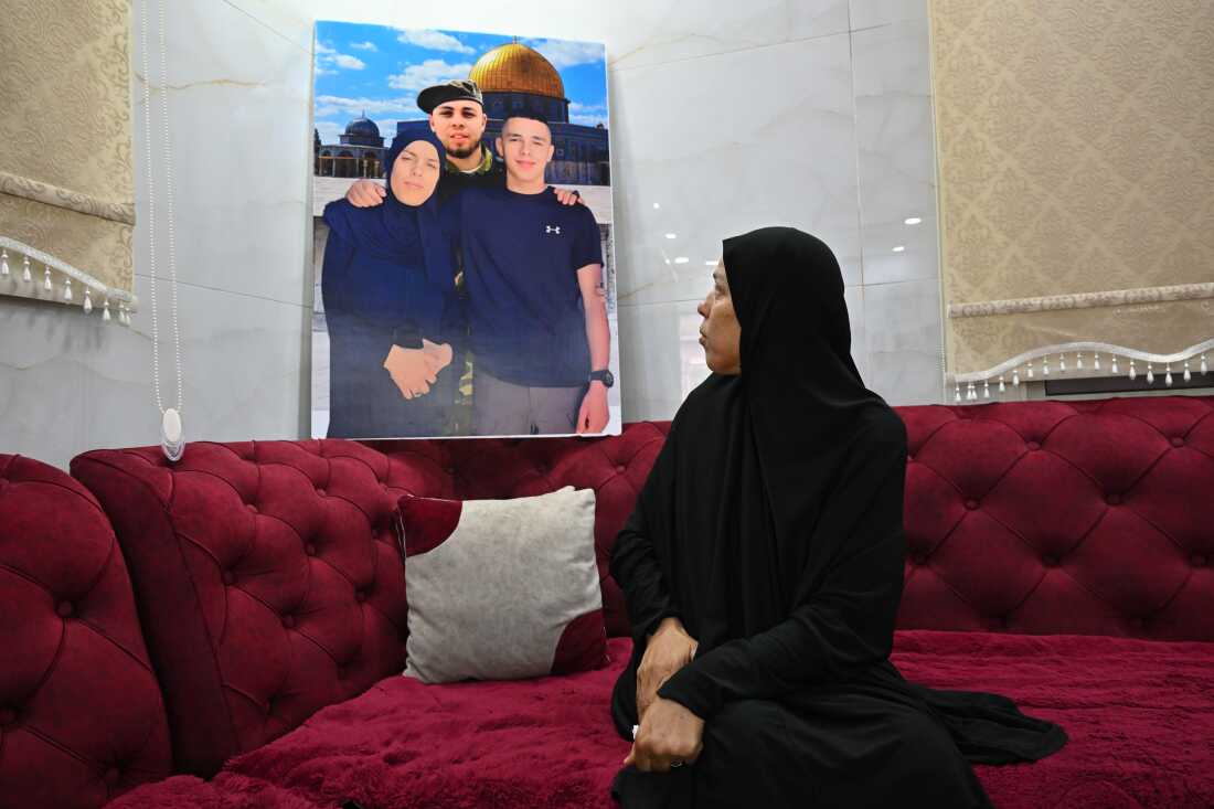 Two of Jameel Amori's sons wer killed in the Jenin refugee camp in the Israeli-occupied West Bank. She sits among memories, including some superimposed images of the three of them together, with a wistful backdrop of the Dome of the Rock holy site in Jerusalem.