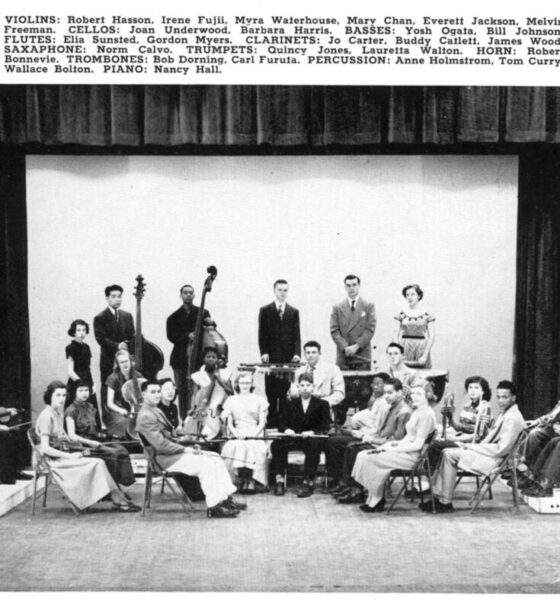 Quincy Jones sits with trumpet along with other students with instruments in the orchestra